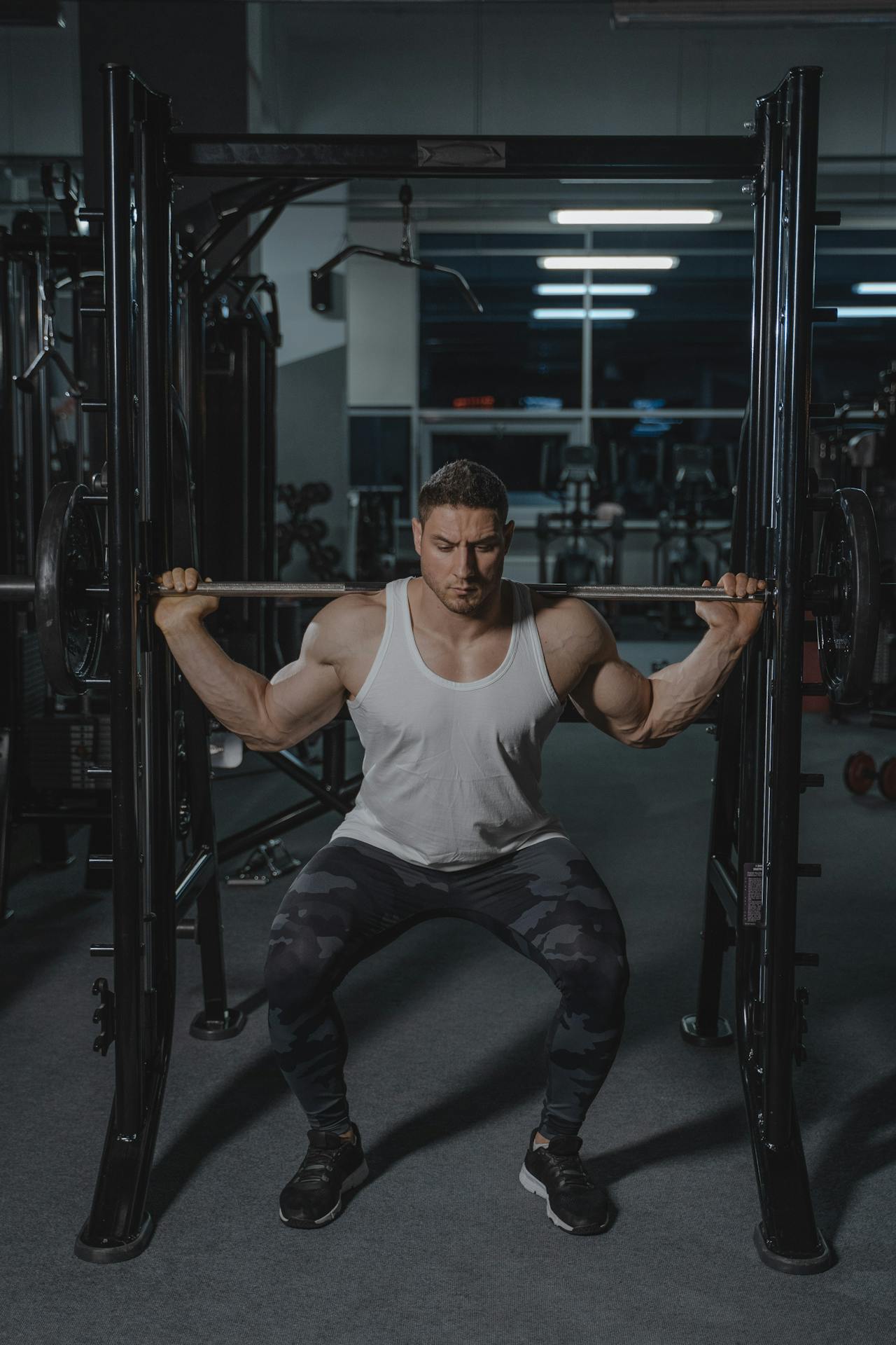 man squatting a bar